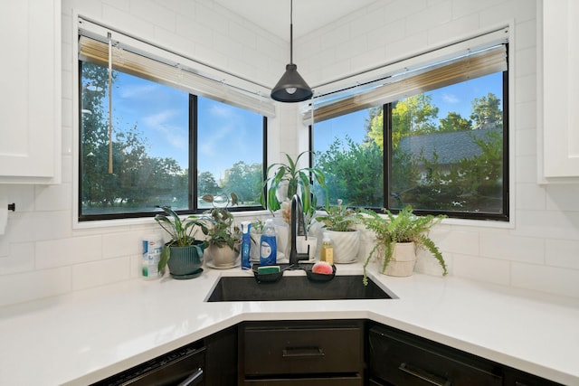 1683 Lakeside Dr, Redding, CA 96001 - kitchen with backsplash, white cabinetry, and light countertops