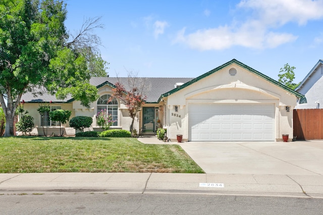 2834 Aspen Glow Ln, Redding, CA 96001 - ranch-style home with a garage, driveway, and stucco siding