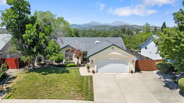 2834 Aspen Glow Ln, Redding, CA 96001 - view of front of house with a garage, concrete driveway, stucco siding, and a mountain view