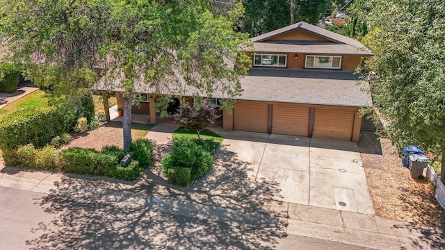 3428 Adams Ln, Redding, CA 96002 - view of front of house featuring concrete driveway, a garage, and a shingled roof