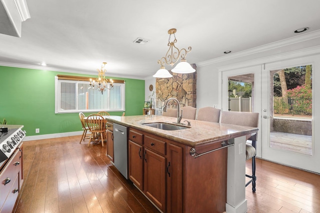3428 Adams Ln, Redding, CA 96002 - kitchen with dishwasher, brown cabinets, a kitchen bar, a chandelier, and ornamental molding