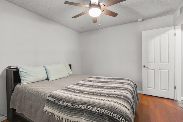 3428 Adams Ln, Redding, CA 96002 - bedroom with wood finished floors, a textured ceiling, and a ceiling fan