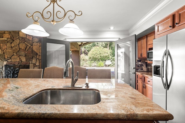 3428 Adams Ln, Redding, CA 96002 - kitchen with appliances with stainless steel finishes, light stone countertops, pendant lighting, brown cabinets, and crown molding