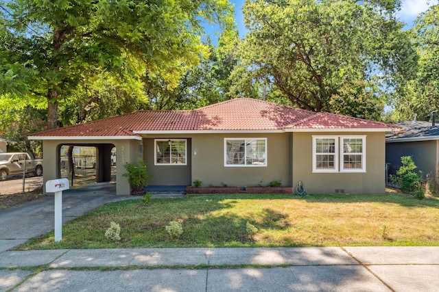 2623 Freebridge St, Redding, CA 96001 - ranch-style home featuring driveway, stucco siding, a front yard, a tile roof, and an attached carport