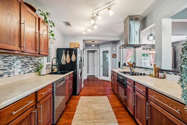 2623 Freebridge St, Redding, CA 96001 - kitchen featuring island exhaust hood, black appliances, dark wood finished floors, tasteful backsplash, and light countertops
