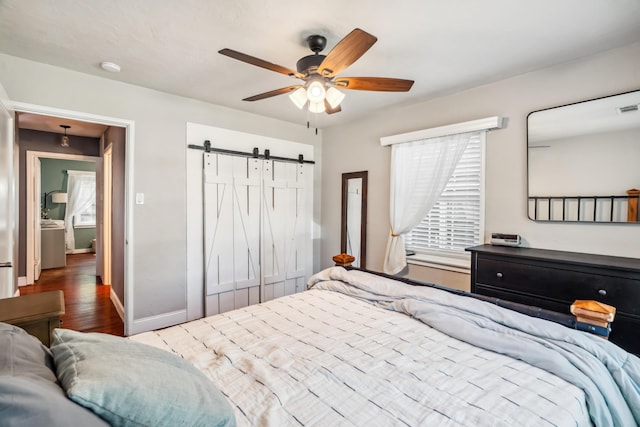 2623 Freebridge St, Redding, CA 96001 - bedroom featuring a barn door, wood finished floors, a ceiling fan, and a closet