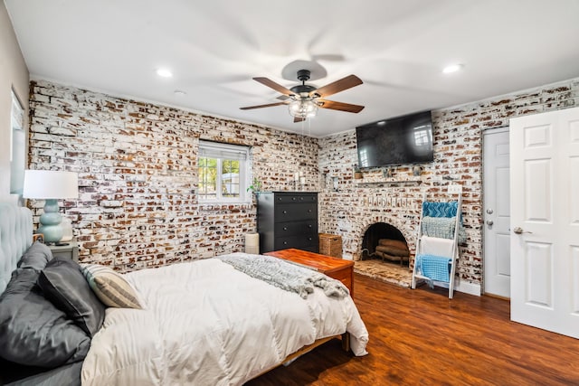2623 Freebridge St, Redding, CA 96001 - bedroom with brick wall, wood finished floors, recessed lighting, a fireplace, and ceiling fan