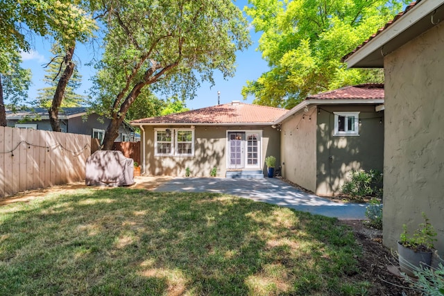 2623 Freebridge St, Redding, CA 96001 - rear view of house with stucco siding, a patio, and a tile roof