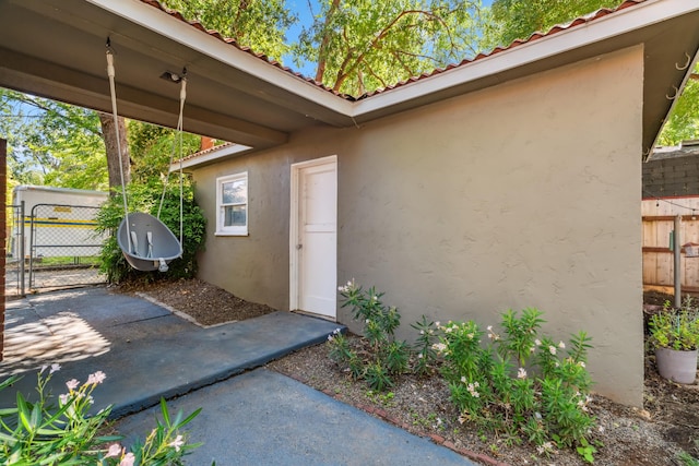2623 Freebridge St, Redding, CA 96001 - property entrance with stucco siding, a gate, a patio area, and a tiled roof