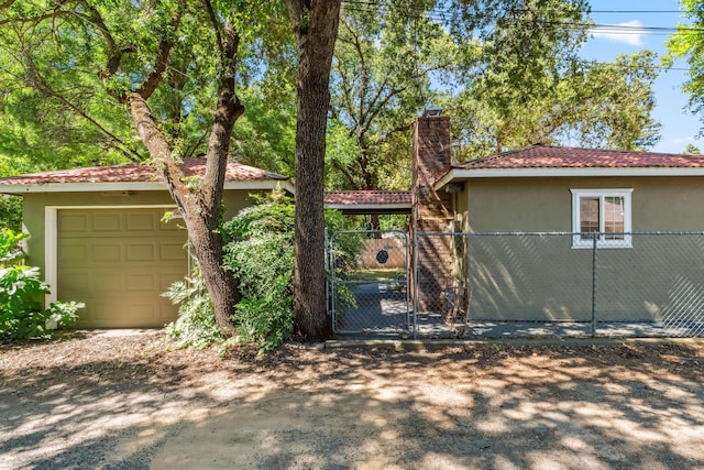2623 Freebridge St, Redding, CA 96001 - view of front of home with stucco siding, a gate, and a chimney