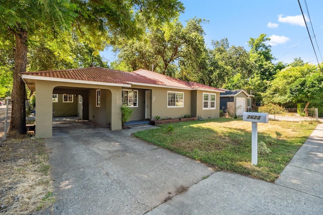 2623 Freebridge St, Redding, CA 96001 - single story home featuring a tiled roof, stucco siding, a shed, driveway, and a carport