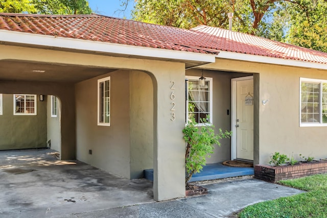 2623 Freebridge St, Redding, CA 96001 - view of exterior entry featuring stucco siding and a tile roof