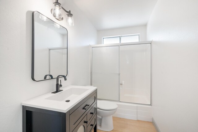3704 Polaris Way, Redding, CA 96002 - bathroom featuring vanity, combined bath / shower with glass door, and wood finished floors