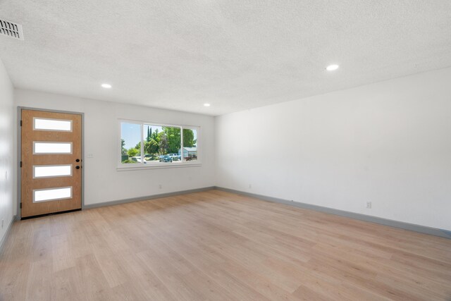 3704 Polaris Way, Redding, CA 96002 - entrance foyer with light wood finished floors, a textured ceiling, and recessed lighting