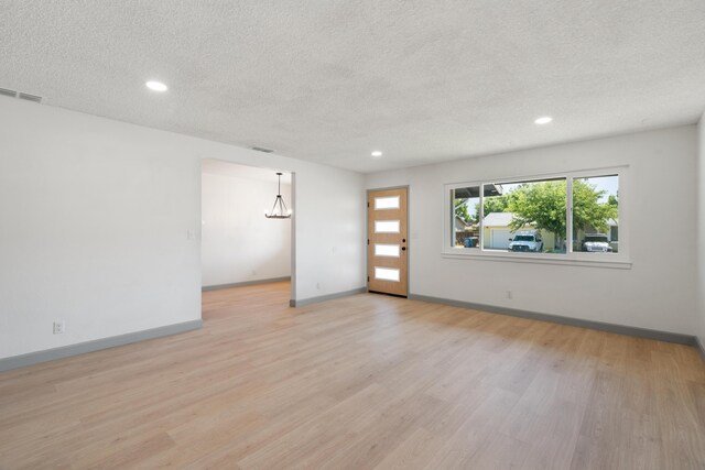 3704 Polaris Way, Redding, CA 96002 - empty room featuring a textured ceiling, light wood finished floors, and recessed lighting