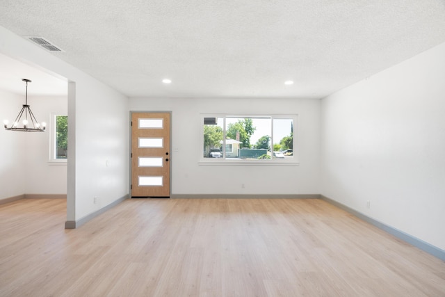 3704 Polaris Way, Redding, CA 96002 - foyer featuring a chandelier, light wood-type flooring, healthy amount of natural light, recessed lighting, and a textured ceiling
