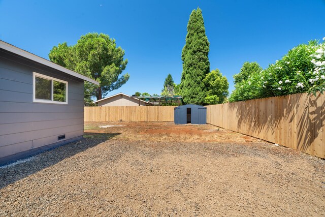 3704 Polaris Way, Redding, CA 96002 - fenced backyard with a storage unit