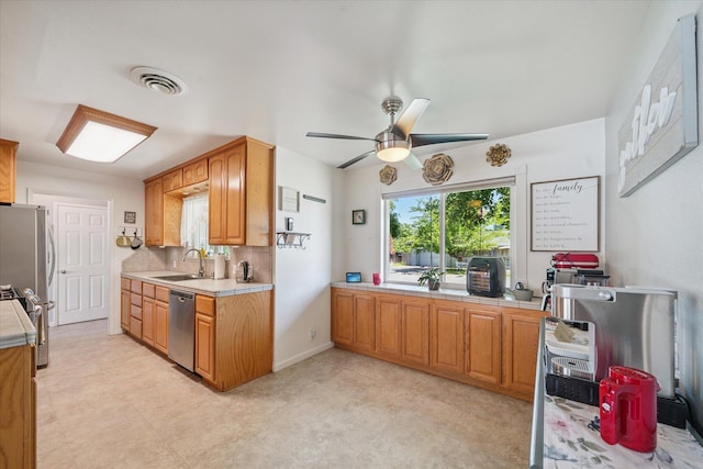 2912 Squire Ave, Redding, CA 96002 - kitchen featuring appliances with stainless steel finishes, a ceiling fan, light flooring, and backsplash