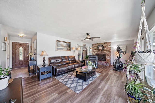 2912 Squire Ave, Redding, CA 96002 - living room with wood finished floors, a ceiling fan, and a fireplace