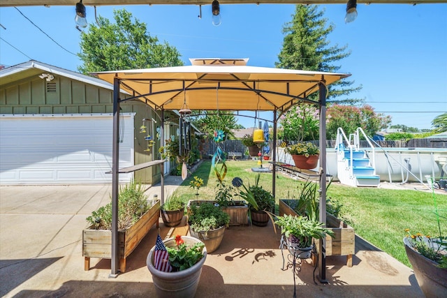 2912 Squire Ave, Redding, CA 96002 - view of patio / terrace featuring a gazebo, a garage, and driveway
