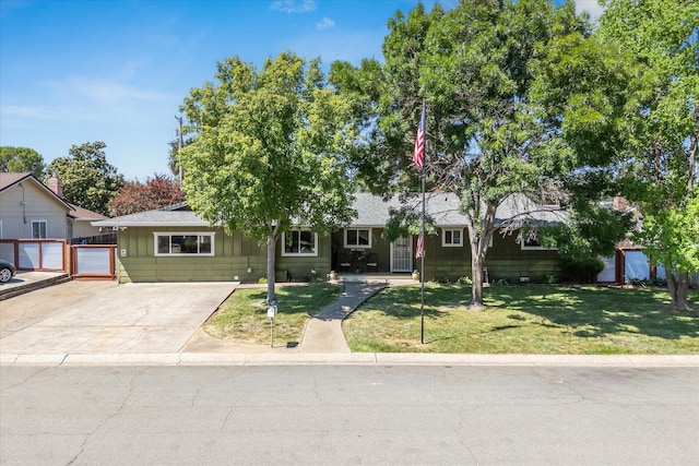 2912 Squire Ave, Redding, CA 96002 - ranch-style home featuring a front yard, roof with shingles, board and batten siding, and driveway