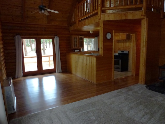 29119 Day Rd, Mcarthur, CA 96056 - kitchen featuring stainless steel range with gas cooktop, healthy amount of natural light, french doors, a ceiling fan, and log walls