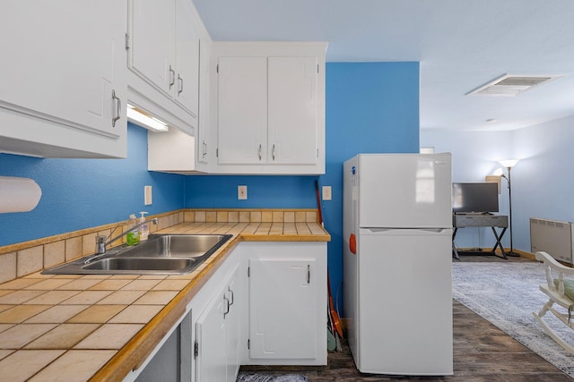 6949 Rector Creek Rd, Igo, CA 96047 - kitchen with freestanding refrigerator, tile counters, white cabinetry, and dark wood finished floors
