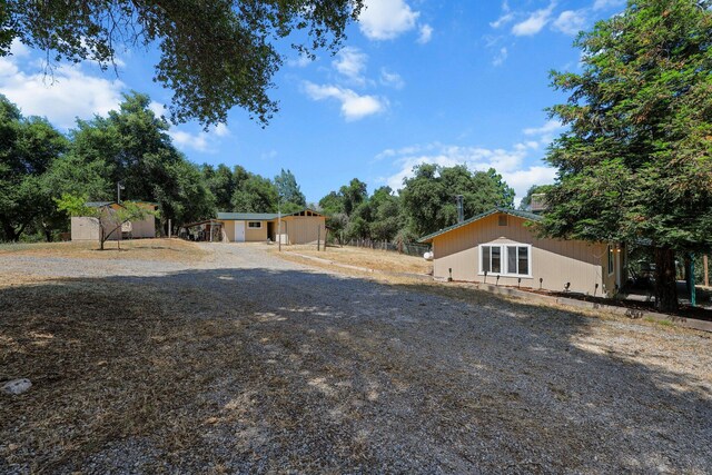 6949 Rector Creek Rd, Igo, CA 96047 - view of front of home featuring a storage shed and view of wooded area