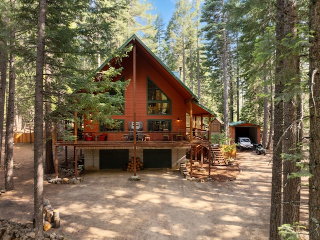 8637 Savannah Way, Shingletown, CA 96088 - view of front of home with driveway, a wooden deck, a garage, and a carport