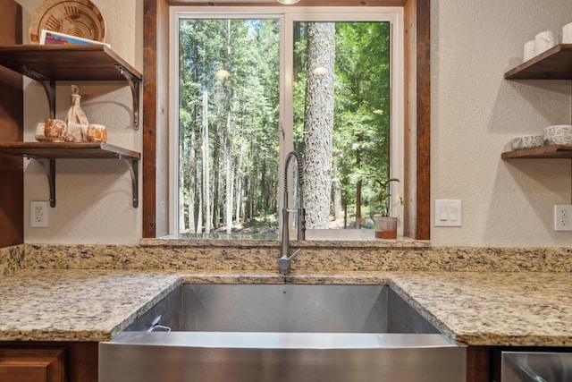 8637 Savannah Way, Shingletown, CA 96088 - kitchen with open shelves, a textured wall, and light stone countertops