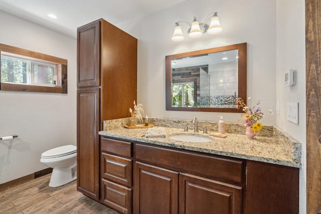 8637 Savannah Way, Shingletown, CA 96088 - full bathroom featuring vanity, wood finished floors, plenty of natural light, and a tile shower