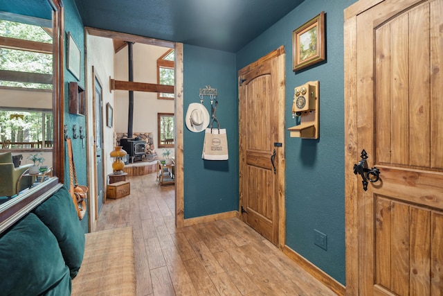 8637 Savannah Way, Shingletown, CA 96088 - foyer entrance featuring a wood stove, light wood-type flooring, and a textured wall