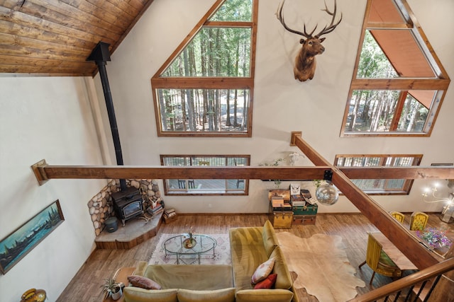 8637 Savannah Way, Shingletown, CA 96088 - living area with a wood stove, wood finished floors, wood ceiling, and high vaulted ceiling