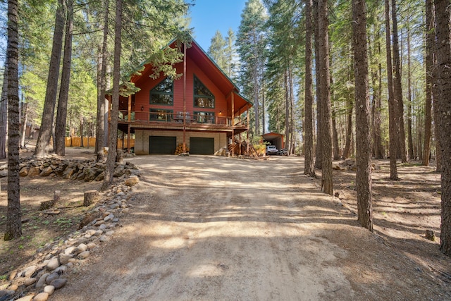 8637 Savannah Way, Shingletown, CA 96088 - rustic home with an attached garage, dirt driveway, and a deck