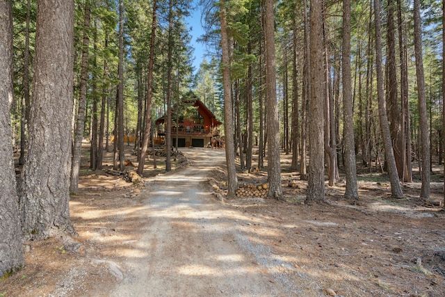 8637 Savannah Way, Shingletown, CA 96088 - view of front of house with driveway, a garage, an outdoor structure, and a forest view