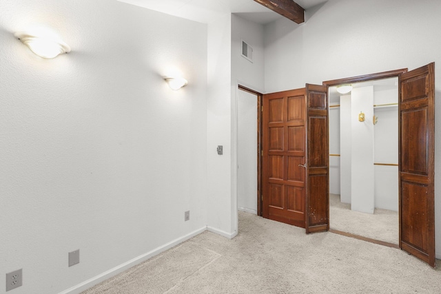 20822 Clough Creek Rd, Redding, CA 96002 - unfurnished bedroom featuring light colored carpet, beam ceiling, a towering ceiling, and a closet