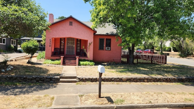 1310 Olive St, Redding, CA 96001 - view of front of property featuring a porch, stucco siding, and a chimney