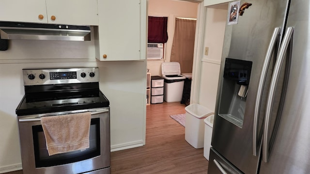 1310 Olive St, Redding, CA 96001 - kitchen featuring appliances with stainless steel finishes, under cabinet range hood, wood finished floors, cooling unit, and white cabinets