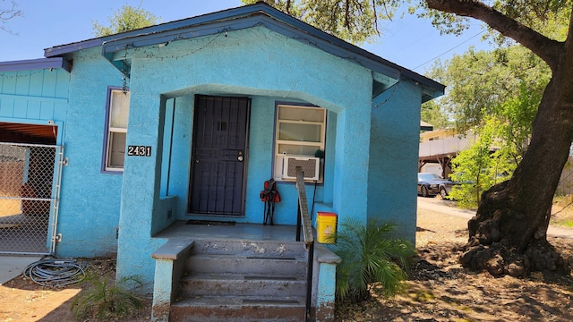 1310 Olive St, Redding, CA 96001 - doorway to property featuring stucco siding and cooling unit