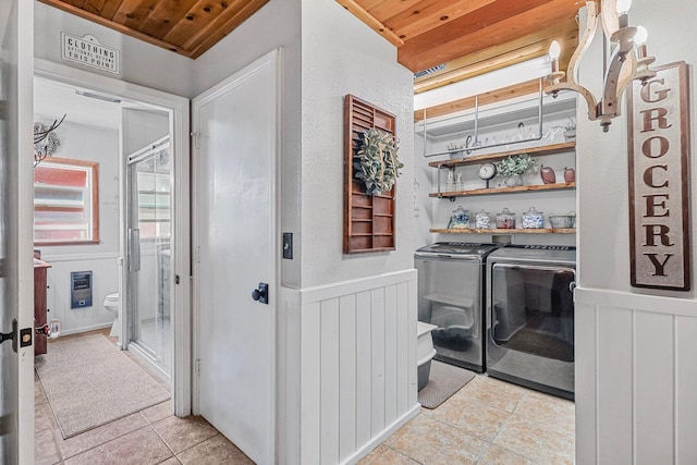 30303 Fremont Way, Oak Run, CA 96069 - laundry room featuring washer and clothes dryer, light tile patterned floors, wainscoting, a decorative wall, and wooden ceiling