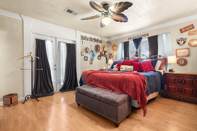 20106 Bonita Way, Redding, CA 96002 - bedroom with crown molding, light wood-type flooring, access to exterior, and ceiling fan
