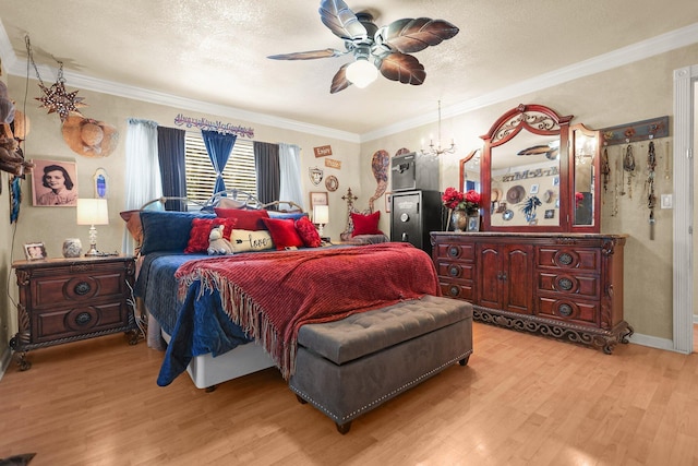 20106 Bonita Way, Redding, CA 96002 - bedroom featuring light wood-style flooring, a chandelier, ornamental molding, a textured ceiling, and a ceiling fan