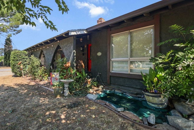 20106 Bonita Way, Redding, CA 96002 - property entrance with stucco siding and a chimney