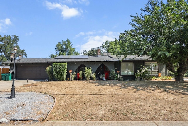 20106 Bonita Way, Redding, CA 96002 - ranch-style home with an attached garage, roof mounted solar panels, and concrete driveway