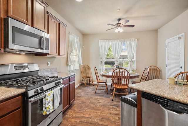 3526 Humbug Dr, Anderson, CA 96007 - kitchen featuring stainless steel appliances, ceiling fan, dark wood finished floors, and brown cabinets
