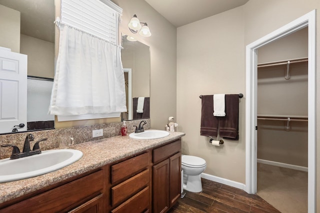 3526 Humbug Dr, Anderson, CA 96007 - full bathroom featuring double vanity, wood finished floors, and a walk in closet