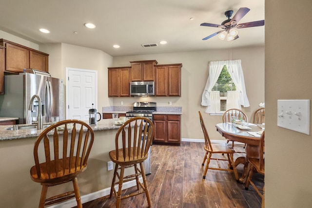 3526 Humbug Dr, Anderson, CA 96007 - kitchen featuring stainless steel appliances, brown cabinetry, a ceiling fan, recessed lighting, and dark wood-style flooring
