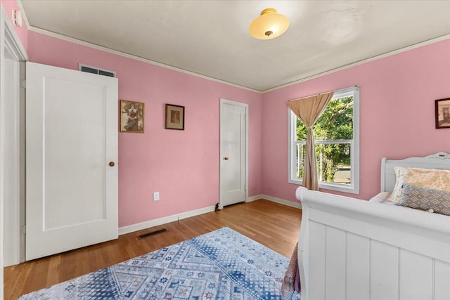 1120 Franklin St, Red Bluff, CA 96080 - bedroom featuring light wood-style flooring and ornamental molding