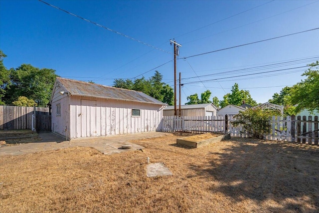 1120 Franklin St, Red Bluff, CA 96080 - fenced backyard featuring a vegetable garden and an outdoor structure