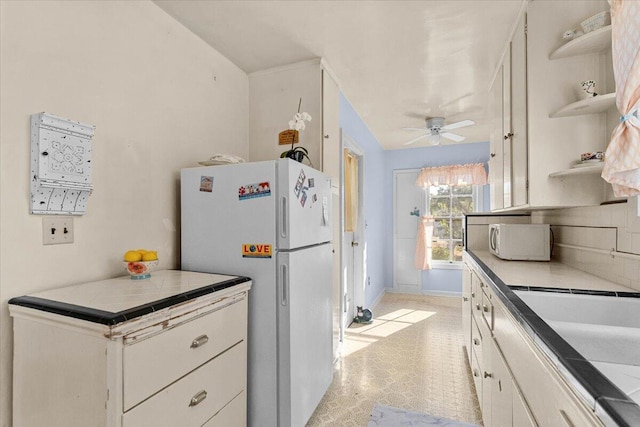 1120 Franklin St, Red Bluff, CA 96080 - kitchen with white appliances, open shelves, white cabinetry, and ceiling fan